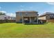 Spacious backyard featuring a well-maintained lawn and a covered patio, perfect for outdoor entertaining at 7514 Absinth Dr Pass, Atlanta, GA 30349