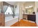 Bright bathroom showcasing a soaking tub and vanity with storage at 7514 Absinth Dr Pass, Atlanta, GA 30349
