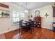 Cozy dining area bathed in natural light, showcasing hardwood floors and stylish decor at 7514 Absinth Dr Pass, Atlanta, GA 30349