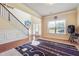 Bright entryway features hardwood floors, staircase, and large window providing natural light at 7514 Absinth Dr Pass, Atlanta, GA 30349
