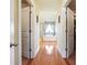 Hallway with hardwood floors leading to a bathroom with a soaking tub at 7514 Absinth Dr Pass, Atlanta, GA 30349