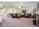 Open-concept living room with plush seating, neutral carpet, and stylish decor at 7514 Absinth Dr Pass, Atlanta, GA 30349