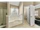 Inviting bathroom with a soaking tub, shower with glass doors, and view to the bedroom at 79 Tiffany Trce, Palmetto, GA 30268