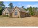 Well-kept brick home boasting a green lawn and mature trees in a tranquil setting at 79 Tiffany Trce, Palmetto, GA 30268