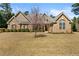 Attractive brick home with a well-maintained lawn and blooming tree in the front yard at 79 Tiffany Trce, Palmetto, GA 30268