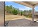 Relaxing outdoor patio area with a textured stone floor and view to the tree lined back yard at 79 Tiffany Trce, Palmetto, GA 30268