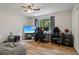Bedroom has hardwood floors, a ceiling fan, a large window, and an open closet at 1720 Little Willeo Rd, Marietta, GA 30068