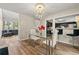 Bright dining area features modern chandelier, glass table, and access to living room and kitchen at 1720 Little Willeo Rd, Marietta, GA 30068
