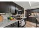 Modern kitchen featuring stainless steel appliances, granite countertops, and ample cabinet space at 1720 Little Willeo Rd, Marietta, GA 30068