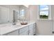 Bright bathroom featuring a double vanity with white countertops and decorative accents at 3048 Shirecrest Ln, Dacula, GA 30019