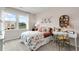 Cozy bedroom with a large window, patterned bedding, and a stylish desk area at 3048 Shirecrest Ln, Dacula, GA 30019
