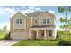 Charming two-story home with a neutral color palette, well-manicured lawn, and inviting front porch at 3048 Shirecrest Ln, Dacula, GA 30019