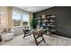 Inviting home office with a modern desk, shelving, and a comfortable accent chair at 3048 Shirecrest Ln, Dacula, GA 30019