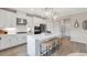 Bright kitchen boasts a large island with seating, stainless steel appliances, and sleek white cabinetry at 3048 Shirecrest Ln, Dacula, GA 30019