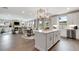 Well-lit kitchen with a center island, modern appliances, and a seamless connection to the dining and living areas at 3048 Shirecrest Ln, Dacula, GA 30019