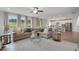 Spacious living room features a large sofa, decorative rug, and seamless flow into the modern kitchen at 3048 Shirecrest Ln, Dacula, GA 30019
