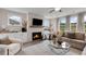 Well-lit living room showcasing a fireplace, built-in shelving, and comfortable seating arrangements at 3048 Shirecrest Ln, Dacula, GA 30019