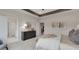 Relaxing main bedroom boasts a tray ceiling, large dresser, and ensuite bath at 3048 Shirecrest Ln, Dacula, GA 30019