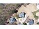 An aerial view of the home showing the roof, driveway, circular drive, mature landscaping, and surrounding neighborhood at 3230 Munsey Ct, Cumming, GA 30041