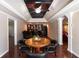 This bar area features wood floors, a dark wood bar with seating, and modern appliances for entertaining guests at 3230 Munsey Ct, Cumming, GA 30041