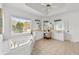 Bright bathroom featuring a jacuzzi style tub, makeup vanity, and tile floors at 3230 Munsey Ct, Cumming, GA 30041