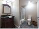 Classic bathroom with a dark wood vanity, black countertop, framed mirror and shower-tub combination at 3230 Munsey Ct, Cumming, GA 30041