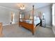 Spacious bedroom featuring a wooden bed, neutral colors, and a ceiling fan at 3230 Munsey Ct, Cumming, GA 30041