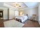 Cozy bedroom features a comfortable bed, rocking chair, sliding barn door and carpet, perfect for relaxation at 3230 Munsey Ct, Cumming, GA 30041
