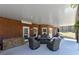 Covered patio features brick construction, outdoor seating, and a serene view of the landscaped backyard at 3230 Munsey Ct, Cumming, GA 30041