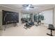 This exercise room includes a treadmill, free weights, and a mirrored wall, ideal for home workouts at 3230 Munsey Ct, Cumming, GA 30041