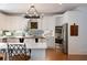 Bright kitchen featuring white cabinets, mosaic tile backsplash, stainless steel appliances, and a wooden kitchen island at 3230 Munsey Ct, Cumming, GA 30041