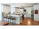 Bright kitchen with ample counter space on the island, white cabinets, and stainless steel appliances, hardwood floors at 3230 Munsey Ct, Cumming, GA 30041