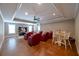 Comfortable living room features red chairs, a ceiling fan, and a large flat screen television for entertainment at 3230 Munsey Ct, Cumming, GA 30041