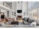 Bright living room with large windows, a stone fireplace, and built-in shelving offering an inviting atmosphere at 3230 Munsey Ct, Cumming, GA 30041