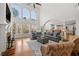 Open living room with stone fireplace and large windows overlooking yard at 3230 Munsey Ct, Cumming, GA 30041
