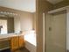 Bathroom featuring a tub, shower, vanity with sink, and updated fixtures at 3615 Hutchinson Trace Dr, Cumming, GA 30040