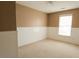 Bedroom with neutral walls and carpet, a window providing natural light, and white wainscoting at 3615 Hutchinson Trace Dr, Cumming, GA 30040