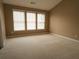 Bright and airy bedroom with plush carpeting and generous natural light from multiple windows at 3615 Hutchinson Trace Dr, Cumming, GA 30040