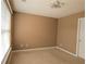 A cozy bedroom with plush carpeting, a ceiling fan, and a window for ample natural light at 3615 Hutchinson Trace Dr, Cumming, GA 30040