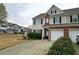 Charming townhome with manicured front yard, driveway, and convenient garage access at 3615 Hutchinson Trace Dr, Cumming, GA 30040