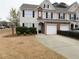 Inviting townhome featuring a brick facade, attached garage, and well-maintained landscaping at 3615 Hutchinson Trace Dr, Cumming, GA 30040