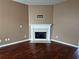Cozy living room featuring a fireplace, hardwood floors, and neutral wall color at 3615 Hutchinson Trace Dr, Cumming, GA 30040