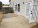 A spacious backyard patio with an open patio door leading to the home's interior at 3615 Hutchinson Trace Dr, Cumming, GA 30040