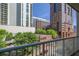 Balcony featuring skyscrapers in the city and tall trees, with a metal safety railing at 44 Peachtree Nw Pl # 629, Atlanta, GA 30309