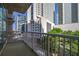 Balcony featuring city views, trees, and a metal safety railing at 44 Peachtree Nw Pl # 629, Atlanta, GA 30309