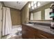Well-lit bathroom features granite countertop and a shower-tub combo with light tile at 44 Peachtree Nw Pl # 629, Atlanta, GA 30309