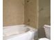 A close up on bathtub with light tile backsplash, shower head, and a stainless steel towel rack at 44 Peachtree Nw Pl # 629, Atlanta, GA 30309