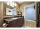 Bathroom features wooden vanity, modern lighting, granite countertop, and towel rack on wall at 44 Peachtree Nw Pl # 629, Atlanta, GA 30309