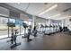 Modern gym with stationary bikes, treadmills, and floor-to-ceiling windows offering views of the city at 44 Peachtree Nw Pl # 629, Atlanta, GA 30309