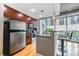 Modern kitchen with stainless steel appliances, breakfast bar, and city view from the large windows at 44 Peachtree Nw Pl # 629, Atlanta, GA 30309